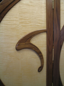 A detail of the black walnut carving on the front of the Art Nouveau screen.